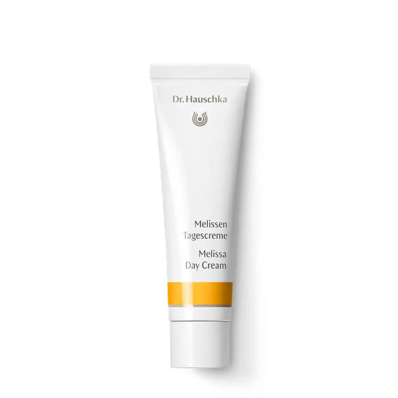 White tube of Dr. Hauschka Melissa Day Cream with an orange stripe.
