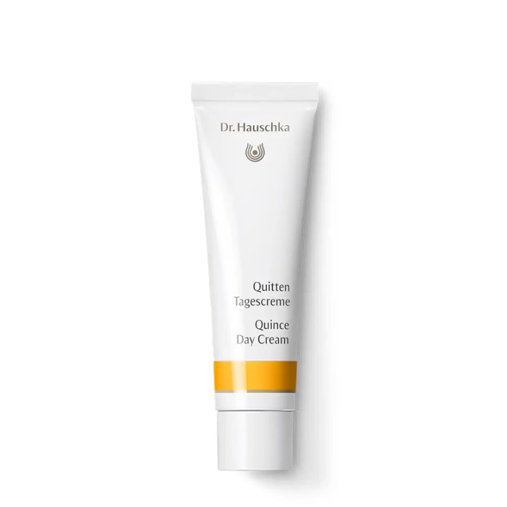 White tube of Dr. Hauschka Quince Day Cream with yellow accent stripe.