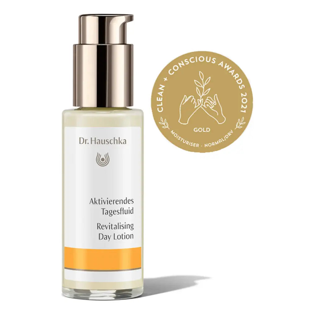 Glass bottle of Dr. Hauschka Revitalising Day Lotion with a gold pump dispenser and award seal.