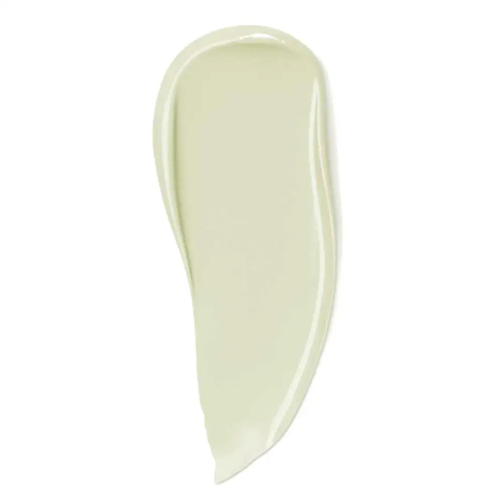 Pale green cosmetic cream smear on white surface.