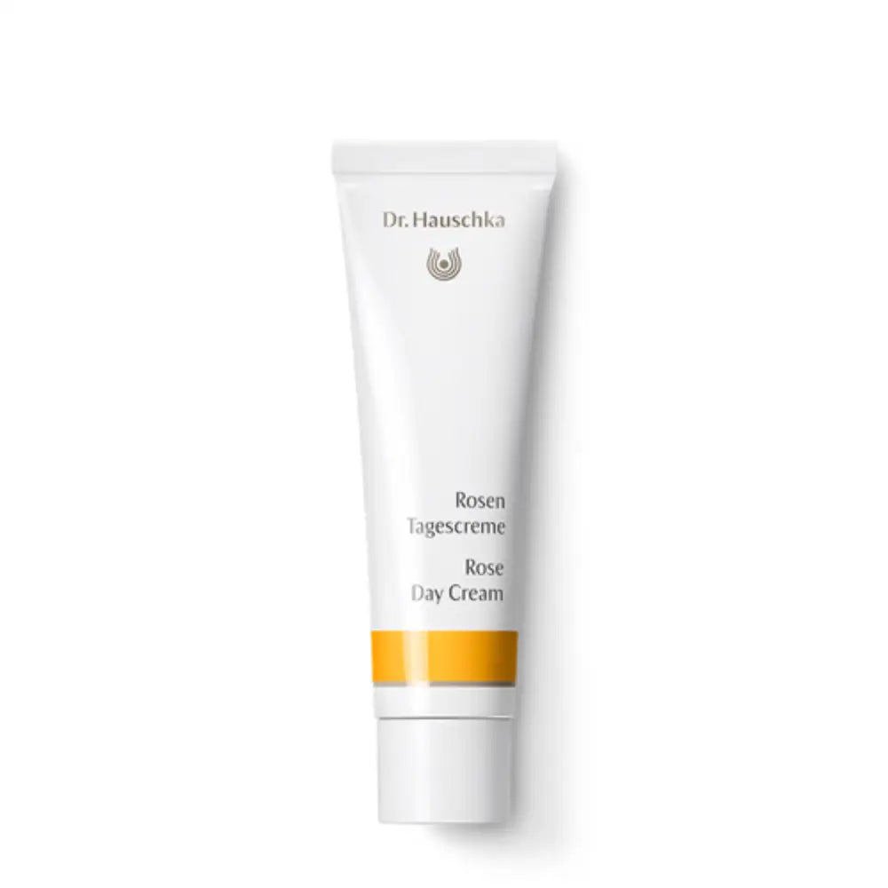 White tube of Dr. Hauschka Rose Day Cream with an orange band on the label.