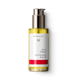 Rose nurturing body oil in a glass bottle with a pump.