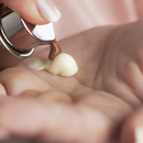 Cosmetic product dispensing into a hand.