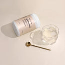 White cylindrical container with text on its label.