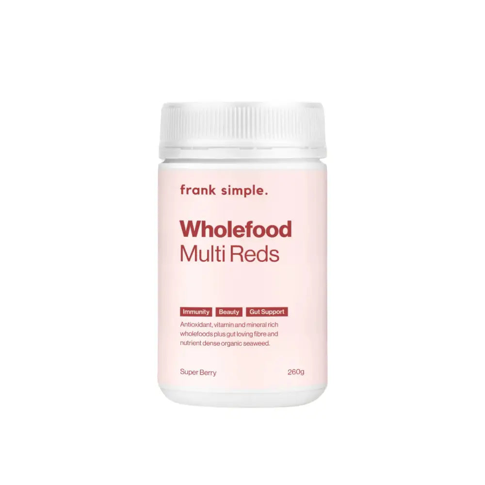 White container of Frank Simple Wholefood Multi Reds supplement powder with pink labeling.