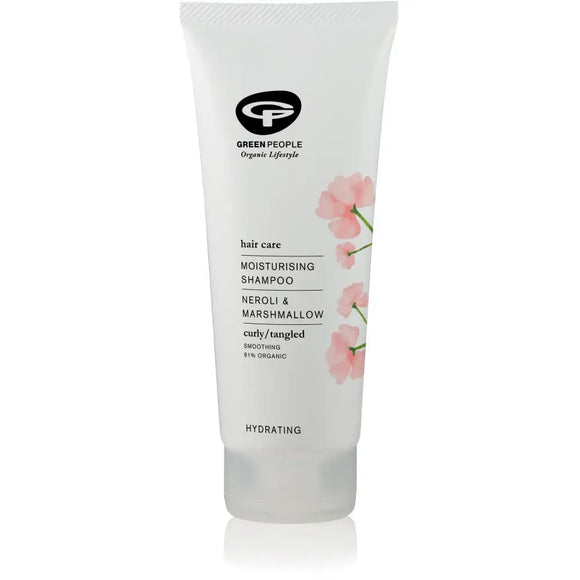White tube of Green People moisturizing shampoo with pink flower designs.