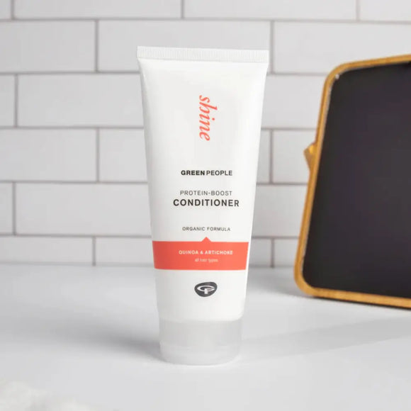 White tube of Green People shine hair conditioner with coral-colored text accents.