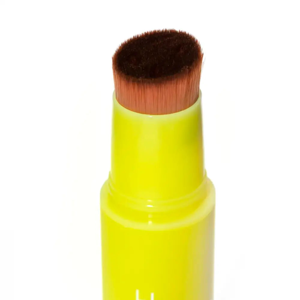 Neon yellow makeup brush with brown bristles.