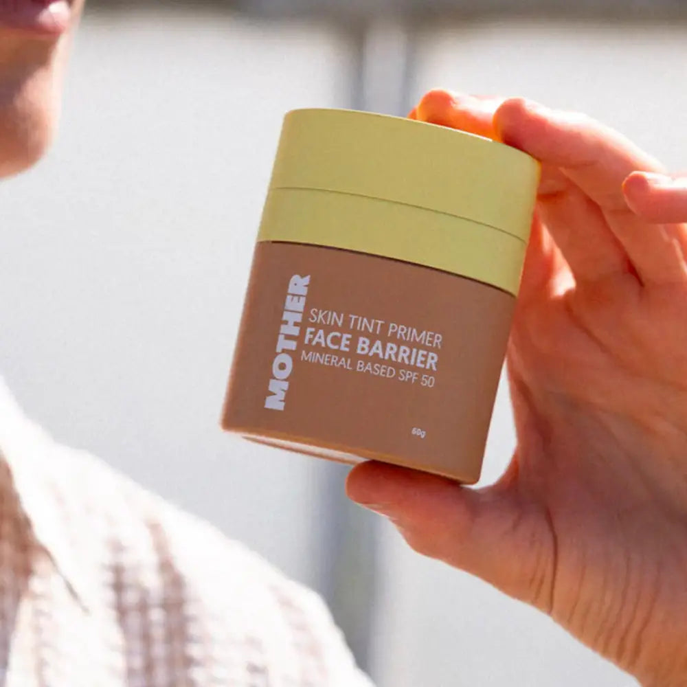 Brown and yellow container of ’Face Barrier’ skin tint product.