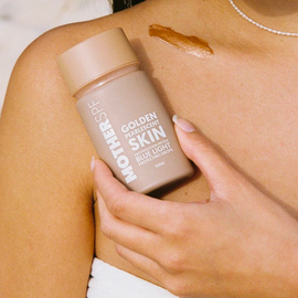 Bottle of golden pearlescent skin drops.