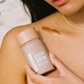 Brown bottle of ’Golden Skin’ beauty product with matte finish packaging.