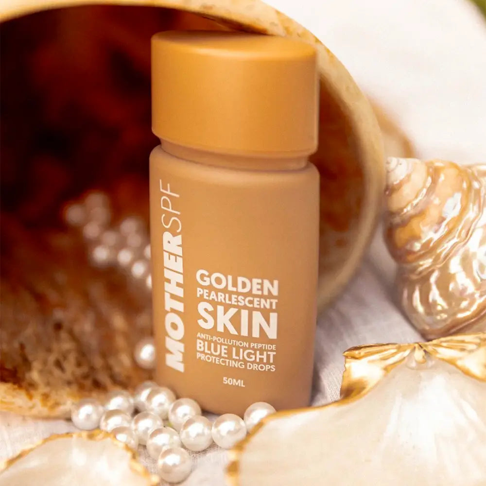 A bottle of Mother SPF Golden Pearlescent Skin blue light protecting cream.