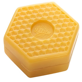 Hexagonal beeswax container with bee emblem.