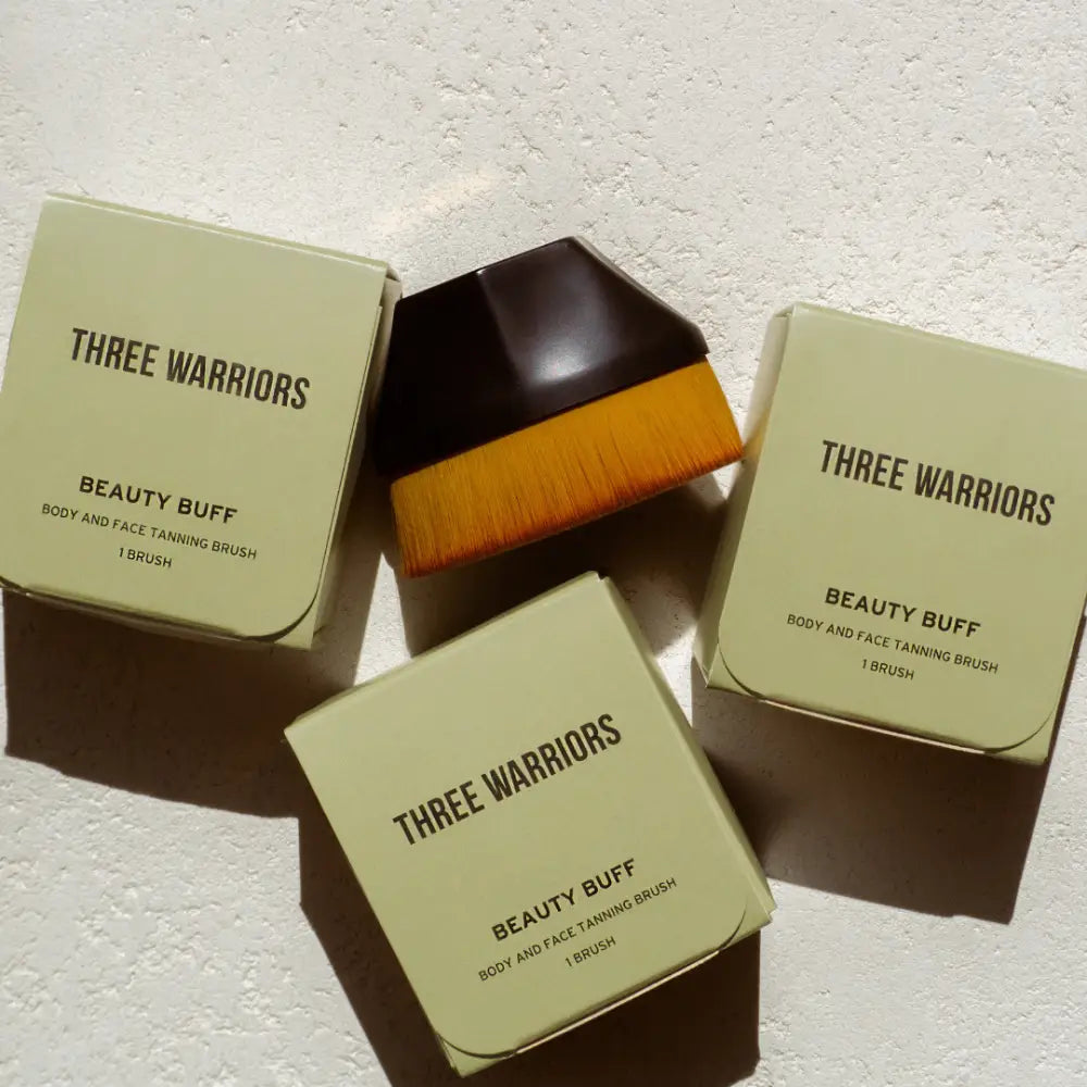 Three Warriors Beauty Buff brushes with sage green packaging.