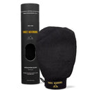 Black exfoliating glove with ’Three Warriors’ branding and its product packaging.
