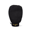 Black tanning glove ’Three Warriors’ text and a logo on its base.