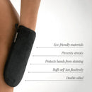 Black double-sided self-tanning mitt with labeled features.