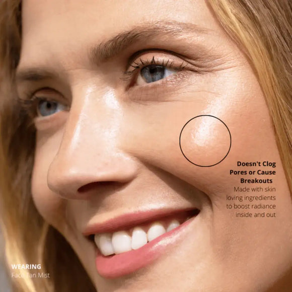 Close-up portrait showing bright blue eyes and a warm smile.