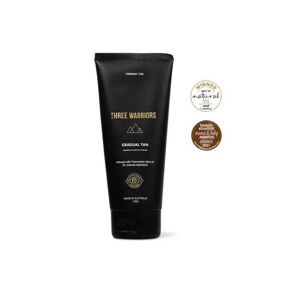 Black tube of Three Warriors gradual tan lotion with gold text and mountain logo.