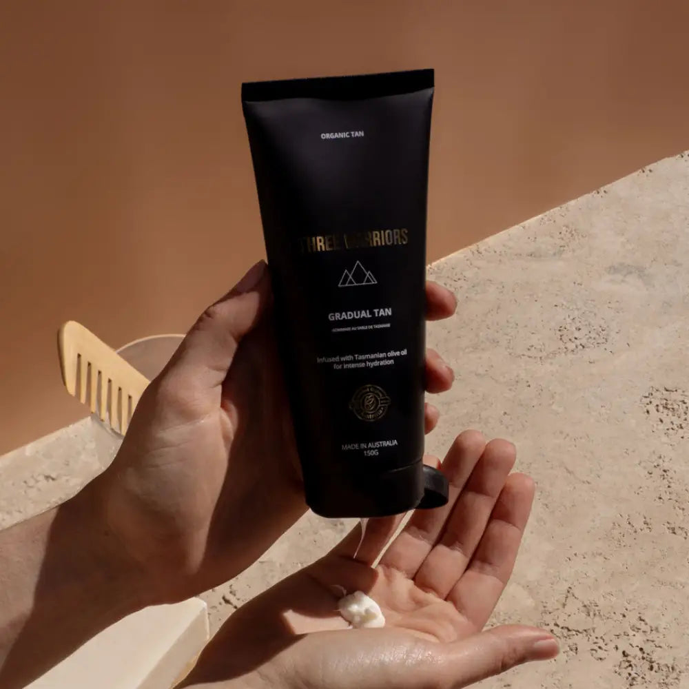 Black cosmetic or skincare tube being dispensed into a palm.