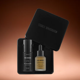 Three Warriors skincare products in a black tin with a brown gradient background