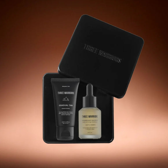 Three Warriors natural tan products in a black box on a gradient brown background