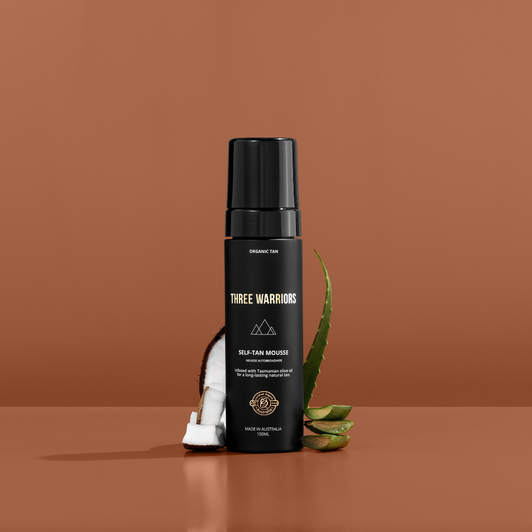 Three warriors self-tan mousse staged a photo with coconut and aloe vera. An organic and natural skincare self tanning mousse